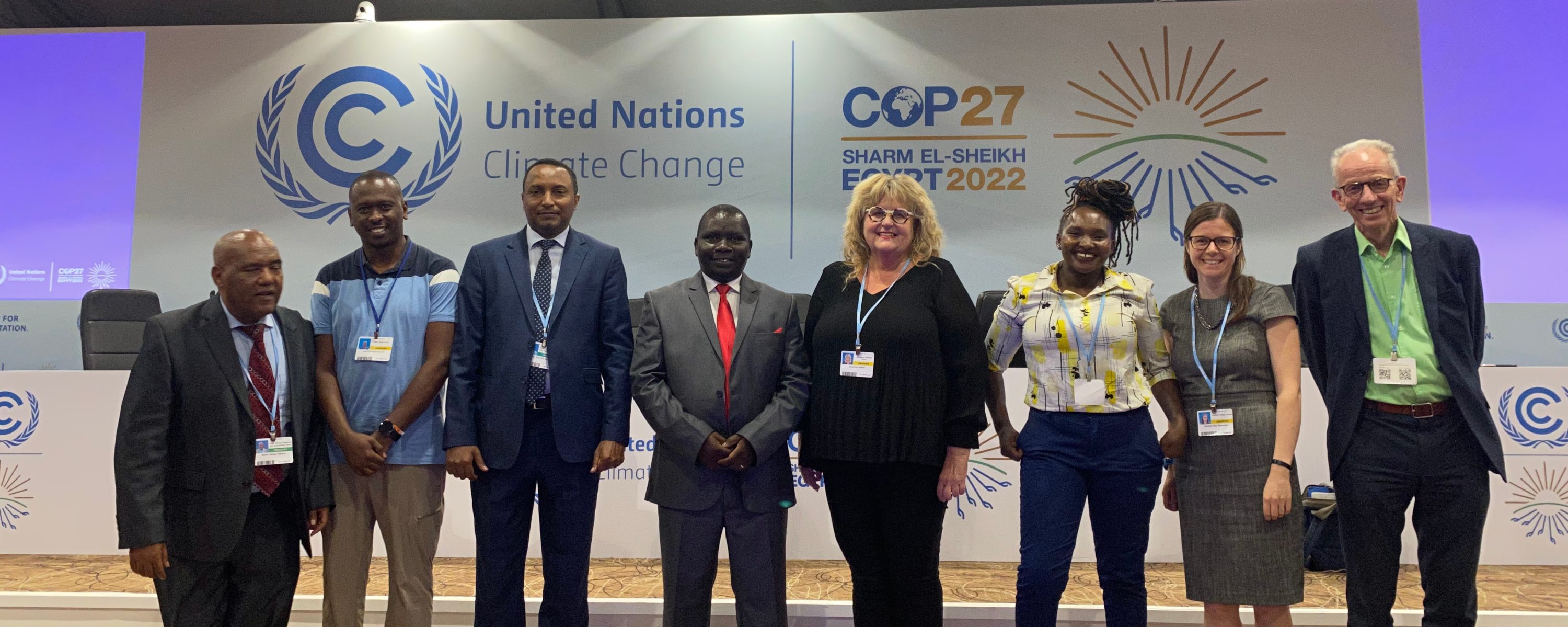 Group photo of event speakers in front of the COP27 branding