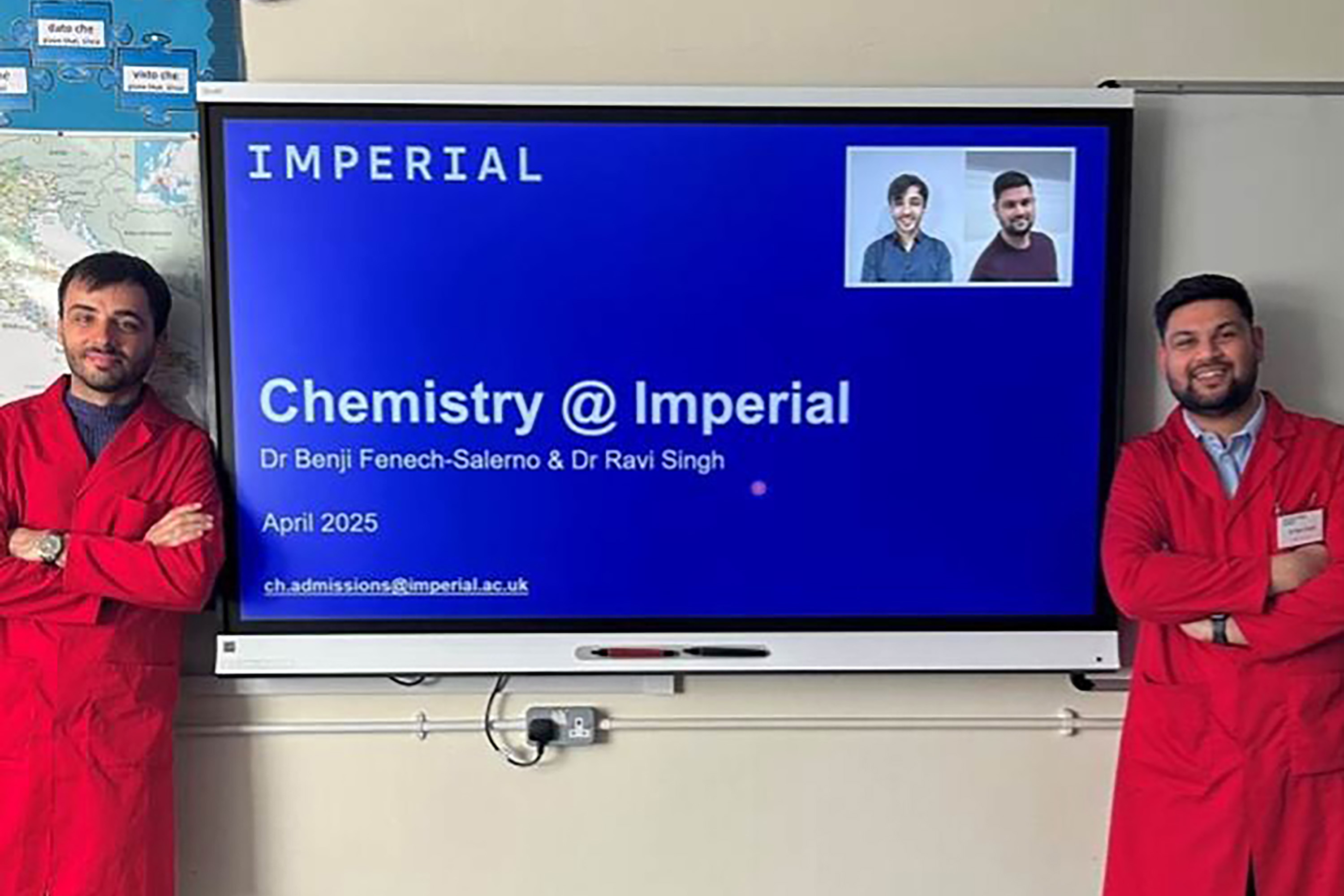 Two tutors standing in front of a TV