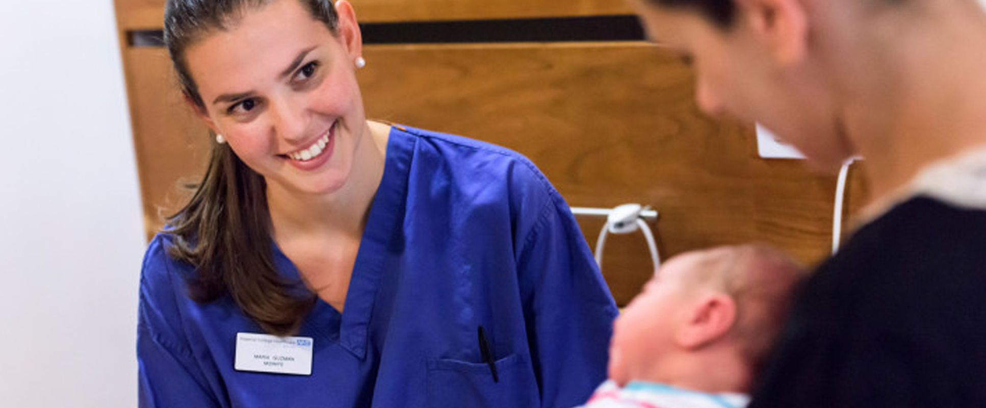 An image of a nurse with a mother holding her baby