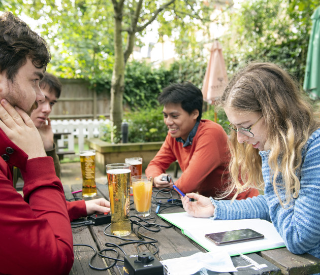 Students from Imperial College Quiz Society sitting outside on a bench