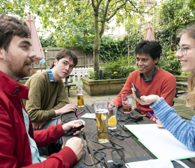 Students from Imperial College Quiz Society sitting outside on a bench