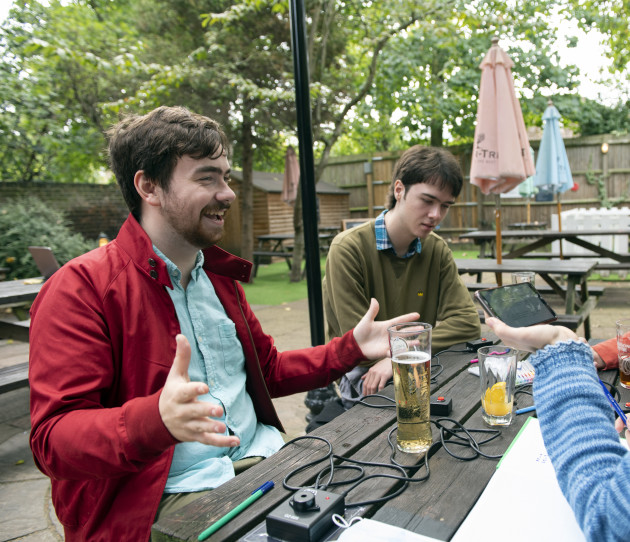 Students from Imperial College Quiz Society sitting outside on a bench