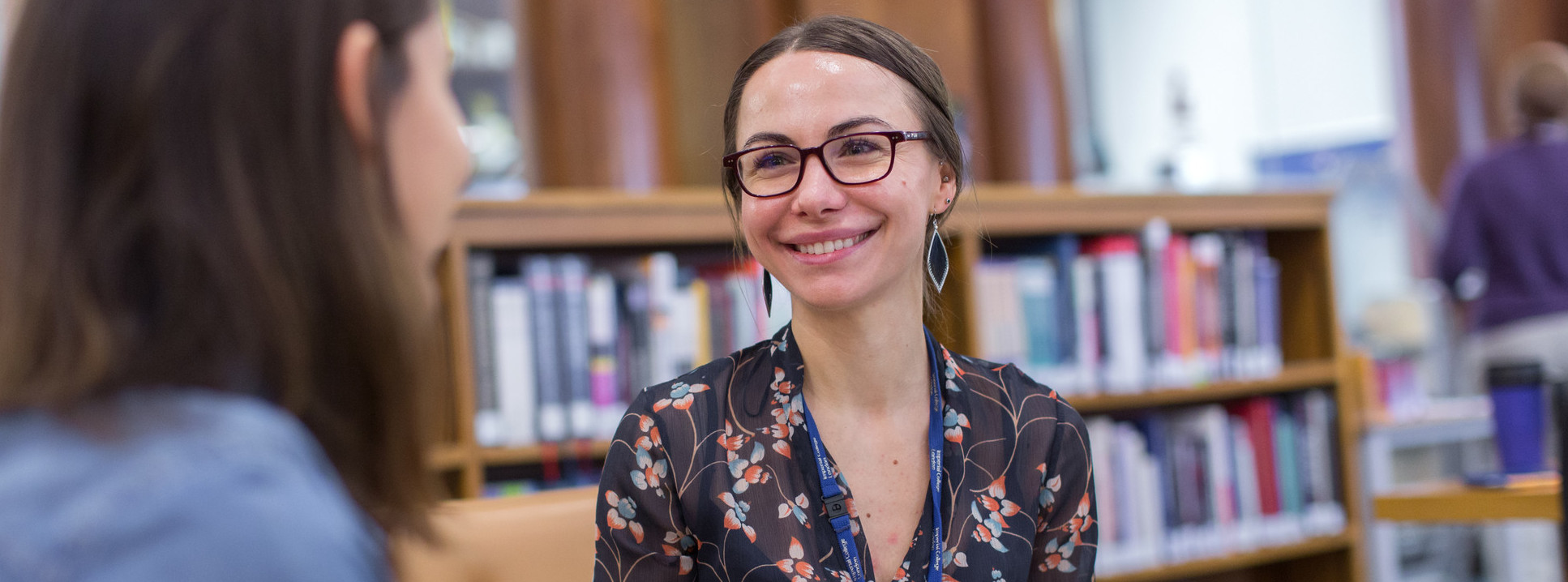 A Master's student smiling in the Fleming Library at Imperial's St Mary's Campus