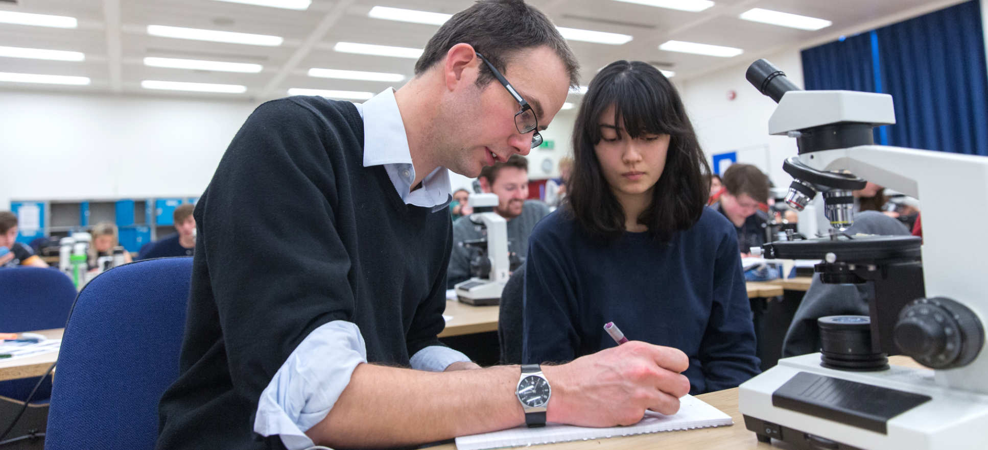 Tutor working with student during practical session