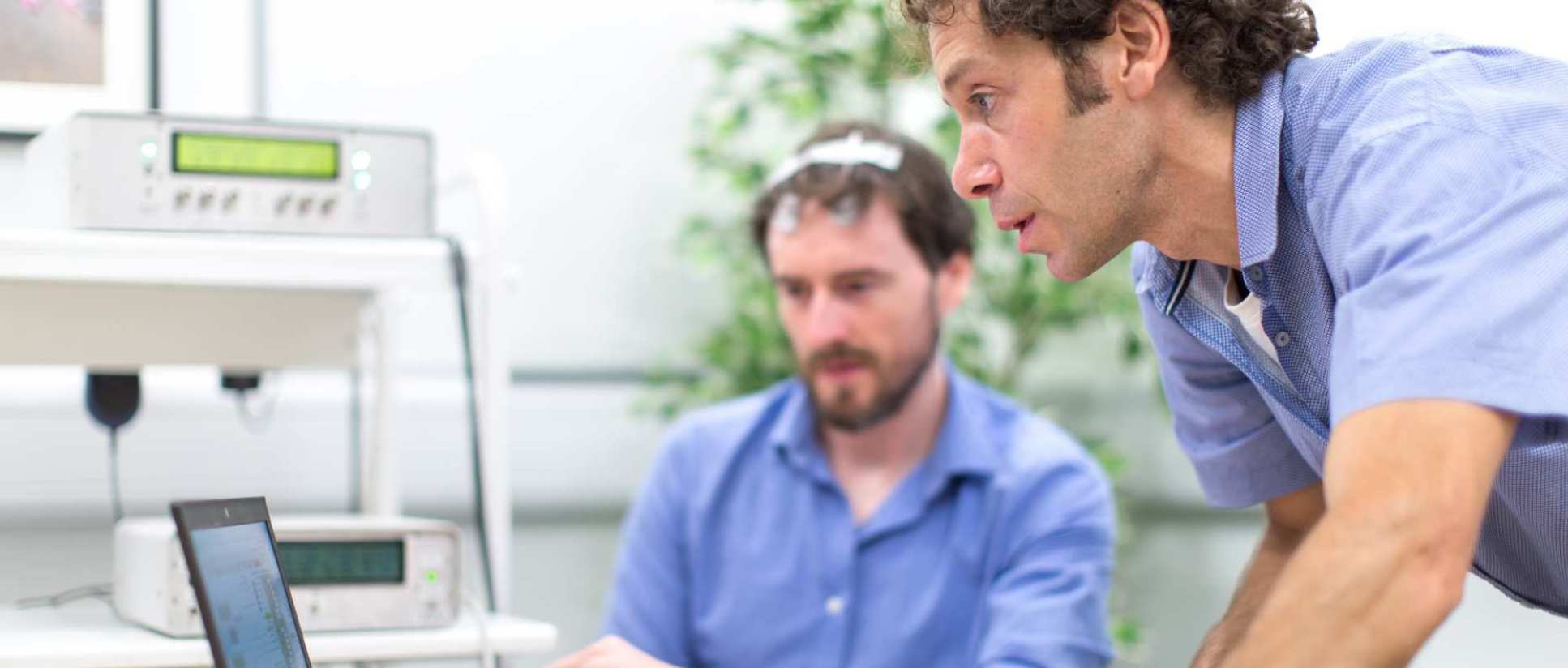 Researchers looking at a computer