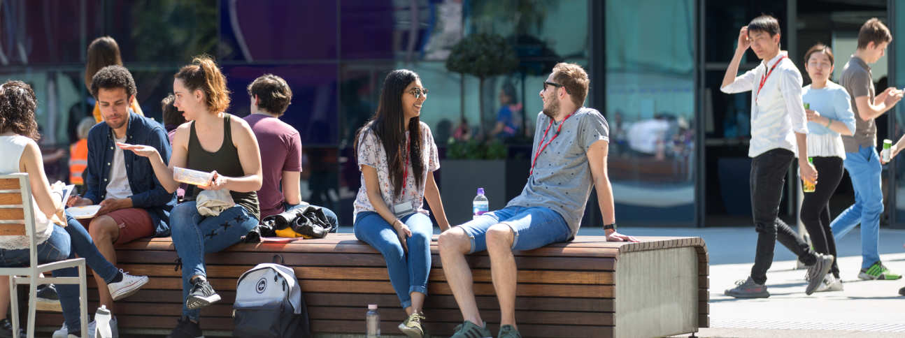 a group of students talking on Dalby Court