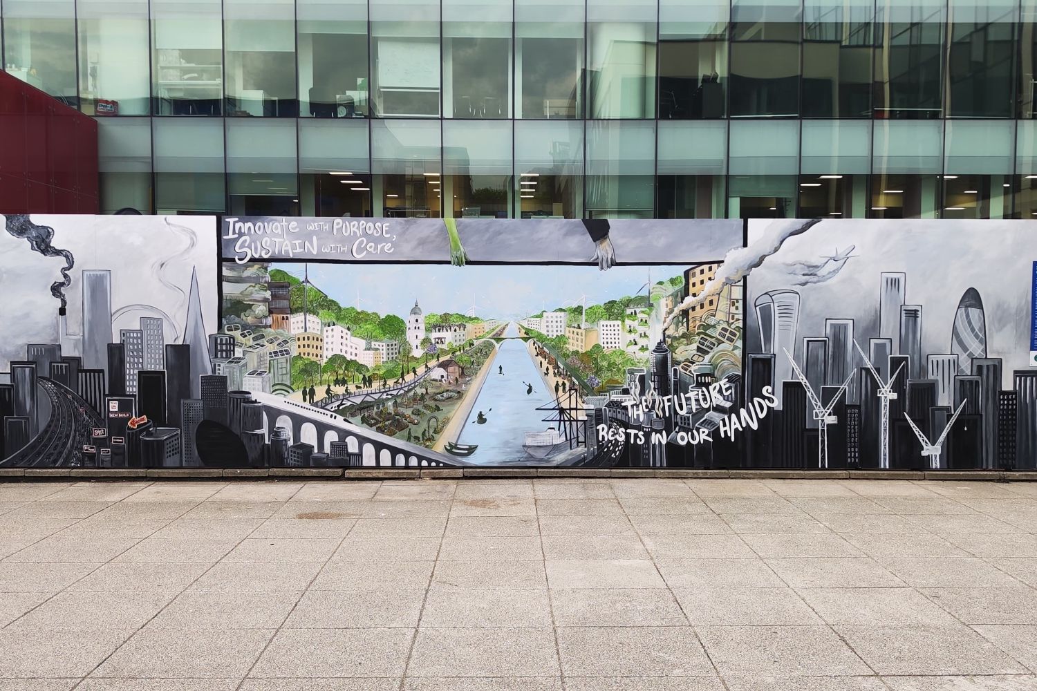an artistic cityscape mural painted onto boards in Dalby Court