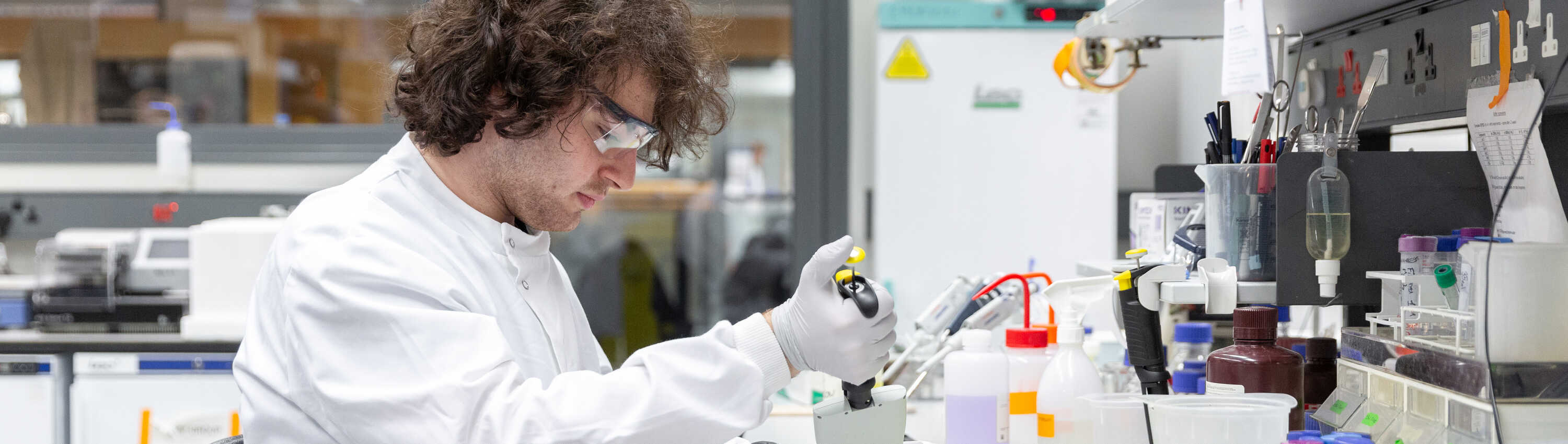 A medicine undergraduate working with a microscope